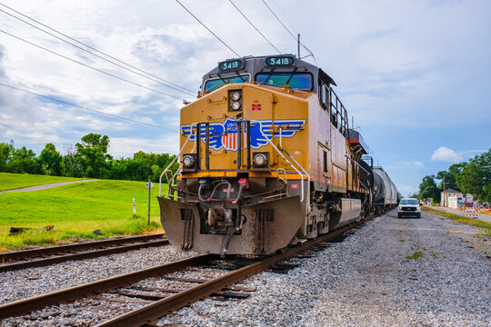 Union Pacific Railroad Locomotive Passes a Pickup Truck Between the Mississippi River Levee and Leake Avenue on June 30, 2022 in New Orleans, LA, USA
