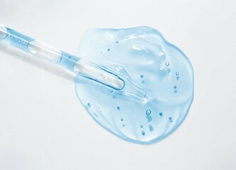 Liquid blue gel or serum on gray background