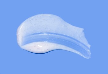 Cosmetic white mask or cleanser texture smudge swatch foam on blue background