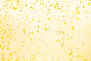 Cream gel oil yellow transparent cosmetic sample texture with bubbles on white background