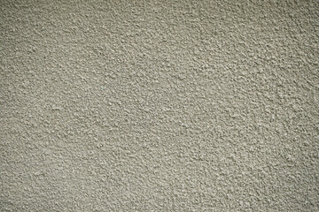 Decorative plaster of beige color with small pimples, wall surface. Overlay texture for interior or exterior design.