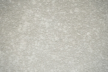 Decorative plaster of gray color with small pimples, wall surface. Texture for interior or exterior design.