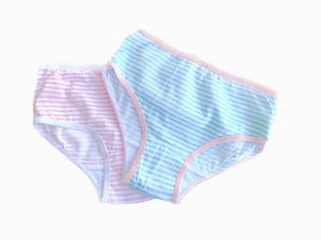Two panties for girls white with blue stripes and white with pink stripes close-up on a white background. Children's knitted cotton underwear.