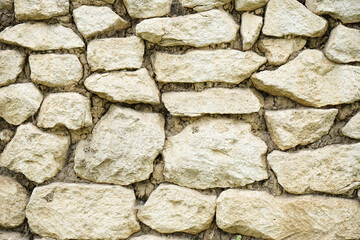 Real stone wall surface with cement. Stone background.