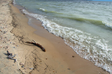 Waves on the sandy shore of the lake.