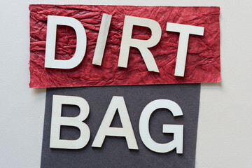 wood type arrange to form the words: dirt bag (on red paper with text and gray paper)