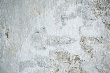 Old white painted limewashed plaster wall texture or background. Close-up.