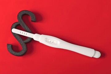 Positive pregnancy test next to paparagraph symbol. Abortion Laws Concept. 