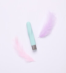 Clitoral vibrator with soft feathers on a white background