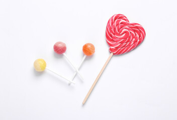 Different lollipops on white background. top view