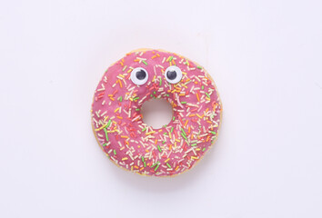 Minimal food concept. Donut with eyes on a white background