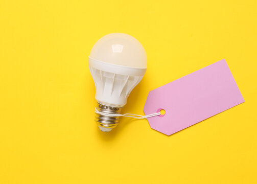Led light bulb with price tag on yellow background
