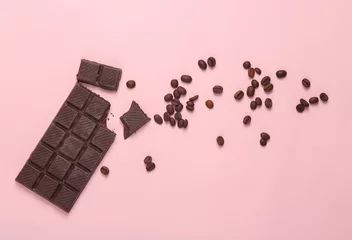 Fotobehang Broken bar of chocolate with coffee beans on a pink background. Top view © splitov27