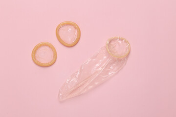 Condoms on a pink background. Contraceptives. Top view