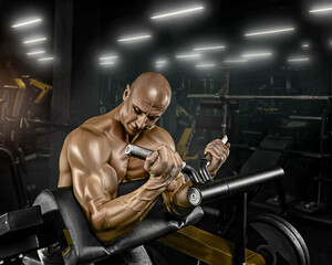 Fototapeta na wymiar a man with a pumped-up body does biceps exercises