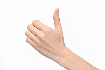 Woman's hand shows thumbs up on white background.