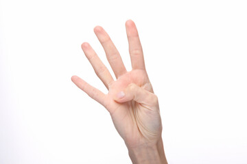 Female hand shows four fingers isolated on white background.