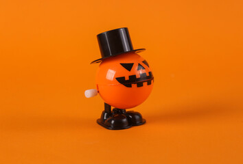 Clockwork halloween toy monster on orange background