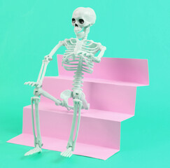 Skeleton on stairs, blue background. Concept art, minimalism