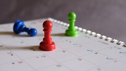 close up of calendar on the table, planning for a business meeting or travel planning concept, pin on calendar, copy space
