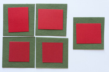 green and red paper tiles on a light background