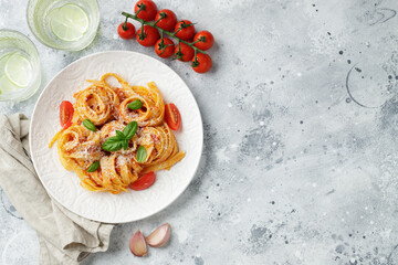 Tasty appetizing classic italian tagliatelle pasta with tomato sauce, cheese parmesan and basil on...