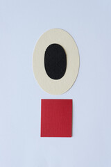oval with black ovoid shape and red paper tile