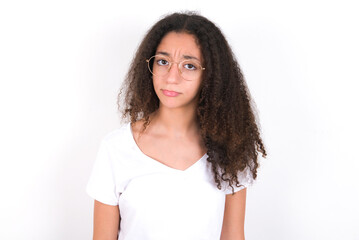 young beautiful girl with afro hairstyle wearing white t-shirt  crying desperate and depressed with tears on his eyes suffering pain and depression. Sad facial expression and emotion concept.