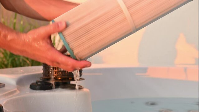 Hot Tub Technician Removing Water Filter and Performing Scheduled Garden SPA Maintenance