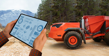 Engineer programs autonomous mining truck using digital tablet