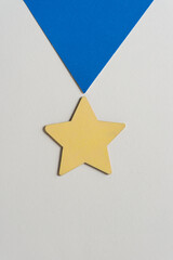 grungy wooden star painted yellow on paper