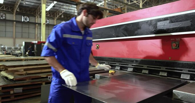 Workers cut sheet metal with modern cutting machines, Metallurgical industry factory.