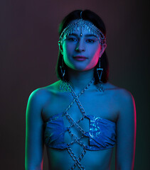 Portrait of a woman wearing fashionable luxury jewelry chains, in an oriental suit and diadem....