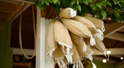 Natural loofah washcloths are hanging at the farmer's market.