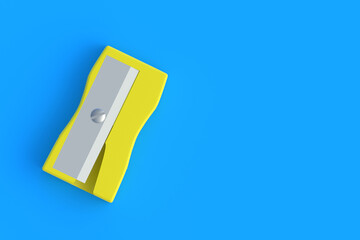 Pencil sharpener on blue background. Stationery accessories. Tool for school. Top view. Copy space. 3d render