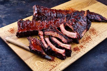 Barbecue pork spare loin ribs St Louis cut with hot honey chili marinade served as close-up on a...