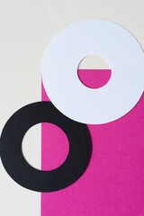 two paper rings on pink and beige