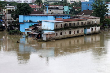 Fototapeta na wymiar House and market shops in the waterlogging due to flood and overflowing water.Huse destruction and damaged.