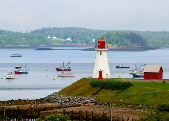 Fototapeta na wymiar lighthouse with boats