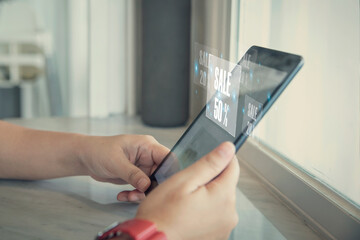 Female using smartphone shopping online with popup notification sale 50% , woman using mobile digital online and social media have a promotion sale on phone screen