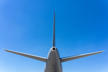 The empennage of the passenger aircraft against background of blue sky.