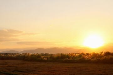 The sun setting down behind the mountain.
