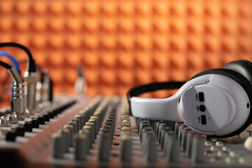Obraz na płótnie Canvas Headphones and sound mixer radio station. Music concept sound record studio