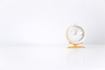rose gold clock on white table and white background for design