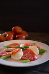 Caprese salad. Tomatoes and mozzarella with basil