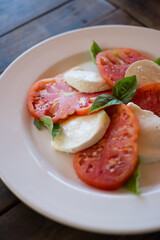 Caprese salad. Tomatoes and mozzarella with basil