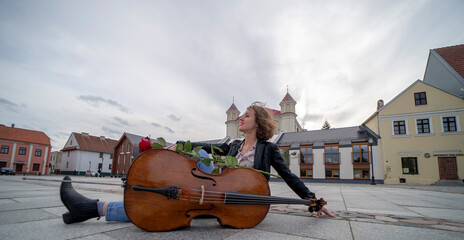 A female musician with a cello on the street