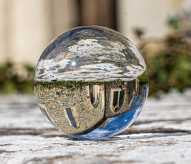 Crystal Photo Ball on Gray Granite Surface reflecting image of Church and historical building in...