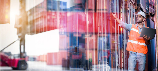 Confident man engineer wearing white safety helmet using computer laptop and check for control loading containers box from Cargo freight ship for import and export, transport