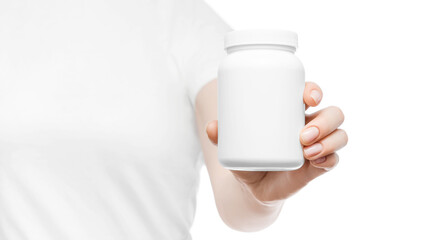 Fototapeta na wymiar Close up of a woman in white t-shirt holding white plastic pill bottle in a hand. Copy space, place for logo or branding.